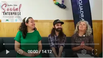 Image of three energized people sitting on a couch next to a Quadrangle Flag